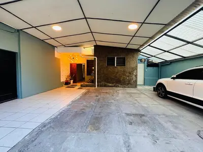 a garage with a white car parked in it at La Mochila Urbana3 in San Salvador
