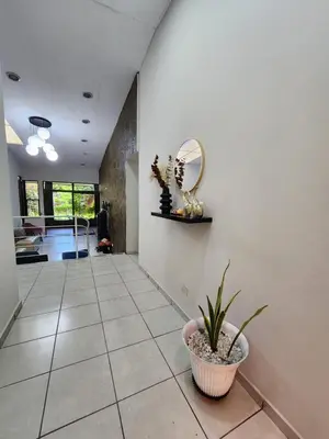 a hallway with a potted plant and a mirror at La Mochila Urbana3 in San Salvador