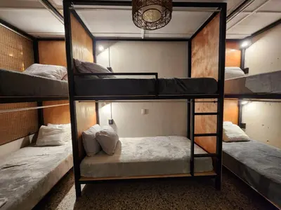 a room with three bunk beds in it at La Mochila Urbana1 in San Salvador