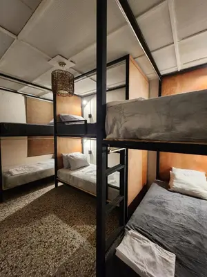 a bunk bed room with three bunk beds in it at La Mochila Urbana1 in San Salvador
