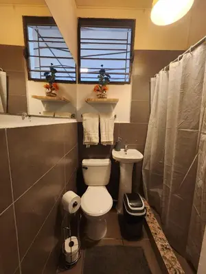 a bathroom with a toilet and a sink at La Mochila Urbana1 in San Salvador