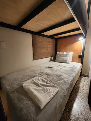 a large bed in a bedroom with a wooden headboard at La Mochila Urbana4 in San Salvador
