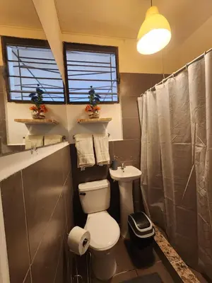 a bathroom with a toilet and a sink at Mochila Urbana6 in San Salvador