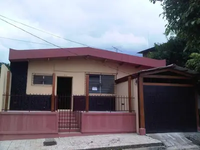 a small house with a red fence in front of it at San Fernando, Ahuachapan in Ahuachapán