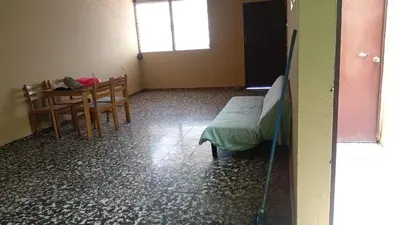 a room with a bed and a table and chairs at San Fernando, Ahuachapan in Ahuachapán