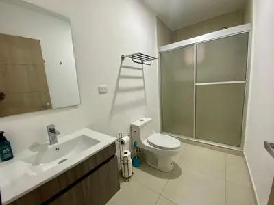 a bathroom with a toilet and a sink and a shower at Luxury Apartment -The Flats in San Salvador