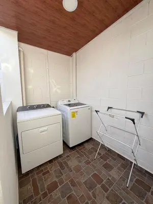 a small laundry room with a washer and dryer at Maadi-Tiny House-Los Ausoles in Ahuachapán