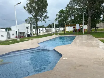 a swimming pool in a yard with trees and buildings at Maadi-Tiny House-Los Ausoles in Ahuachapán