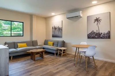 a living room with a couch and a table at 2 Bedroom Apartment with full beds and bunk beds in El Zonte