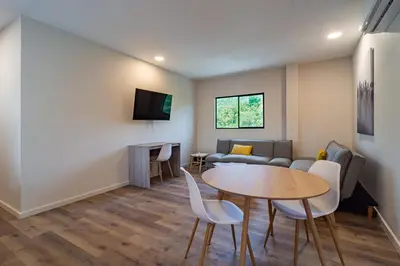 a living room with a table and a couch at 2 Bedroom Apartment with full beds and bunk beds in El Zonte