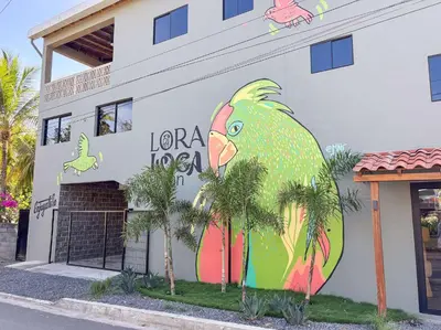 a building with a painting of a chicken on it at 2 Bedroom Apartment with full beds and bunk beds in El Zonte