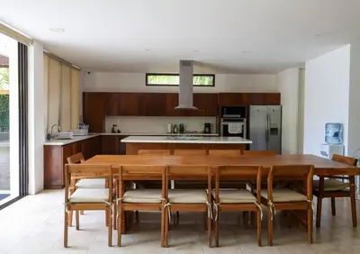 a kitchen with a large wooden table and chairs at Then open space allowed for us to enjoy a big gathering in El Zapote