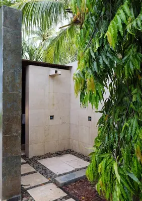 a shower stall in a garden with trees at Then open space allowed for us to enjoy a big gathering in El Zapote