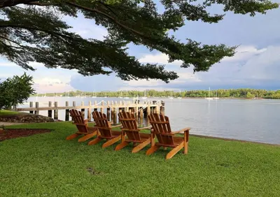 a group of chairs sitting on the grass by the water at Then open space allowed for us to enjoy a big gathering in El Zapote