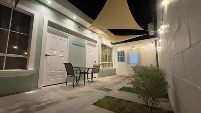 a patio with a table and chairs and a building at Cerca de todo en La Union in La Unión