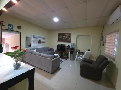 a living room with two couches and a table at Beautiful and comfortable house in Sonsonate