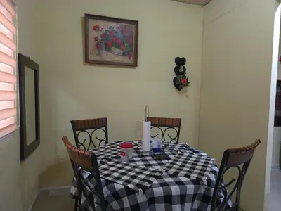 a dining room table with a black and white checkered table cloth at Beautiful and comfortable house in Sonsonate