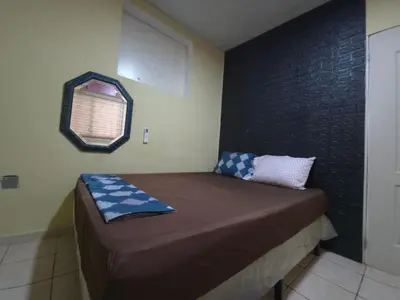 a small bed in a room with a window at Beautiful and comfortable house in Sonsonate