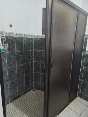 a shower with a glass door in a bathroom at Hotel Ohana in San Juan Talpa