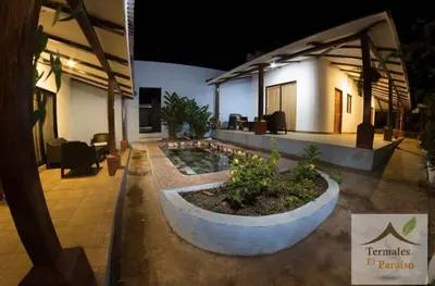 a building with a garden in front of a building at Termales El Paraíso in Turín