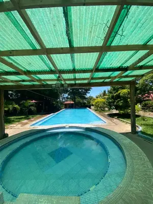 an empty swimming pool with a green roof at Termales El Paraíso in Turín