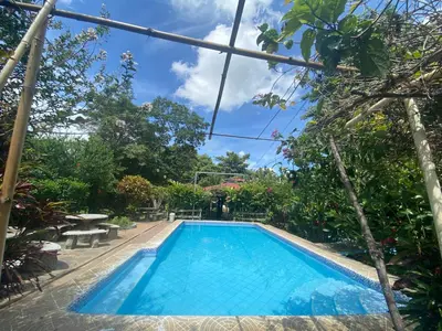 a swimming pool with blue water and trees at Termales El Paraíso in Turín