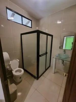 a bathroom with a shower and a toilet and a sink at Termales El Paraíso in Turín