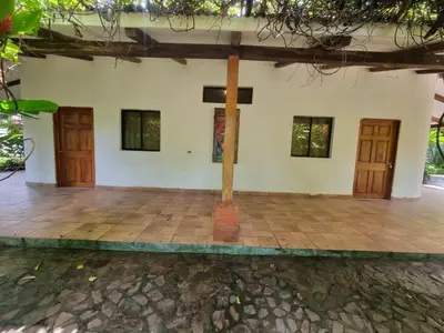 a house with two wooden doors and a tile floor at Termales El Paraíso in Turín