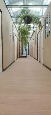 an empty hallway in a building with a glass ceiling at Noche de Luna in San Salvador