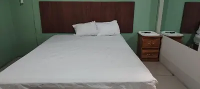 a bedroom with a large white bed with two night stands at Noche de Luna in San Salvador