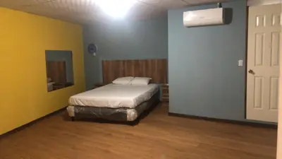 a bedroom with a bed in a room with yellow walls at Noche de Luna in San Salvador
