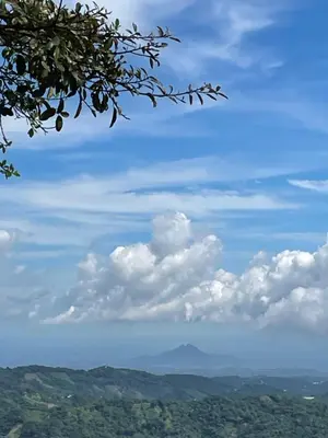 a blue sky with clouds and mountains in the distance at Bed Room San Francisco Chinameca in San Francisco Chinameca