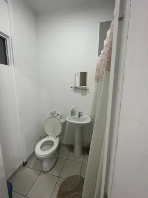 a white bathroom with a toilet and a sink at Bed Room San Francisco Chinameca in San Francisco Chinameca