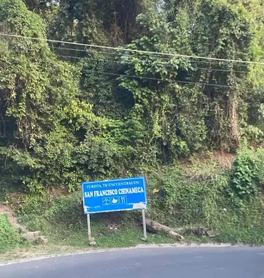 a blue sign on the side of a road at Bed Room San Francisco Chinameca in San Francisco Chinameca