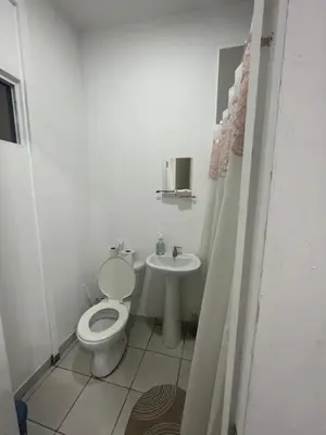a white bathroom with a toilet and a sink at Bed Room San Francisco Chinameca in San Francisco Chinameca