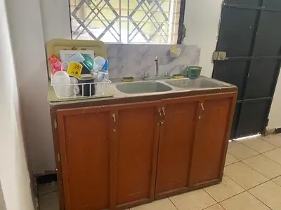 a kitchen counter with a sink and a window at La Casa de Lourdes in Colón