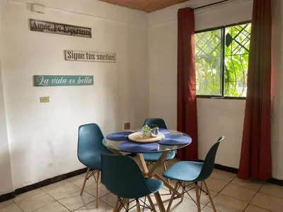 a dining room with a blue table and chairs at La Casa de Lourdes in Colón