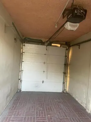 a garage door in a room with a brick floor at La Casa de Lourdes in Colón