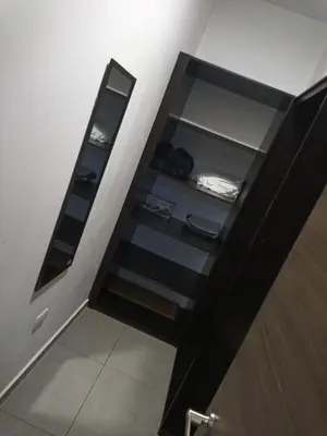 a bathroom with a stairwell with a mirror at Apartamento centrico con vista exepcional al volcan de San Salvador in San Salvador