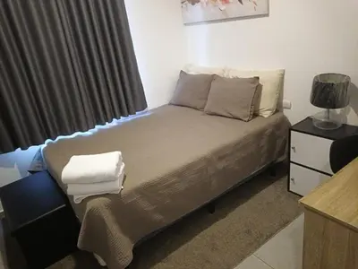 a small bed in a room with a window at Apartamento centrico con vista exepcional al volcan de San Salvador in San Salvador