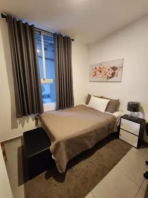 a bedroom with a large bed and a window at Apartamento centrico con vista exepcional al volcan de San Salvador in San Salvador