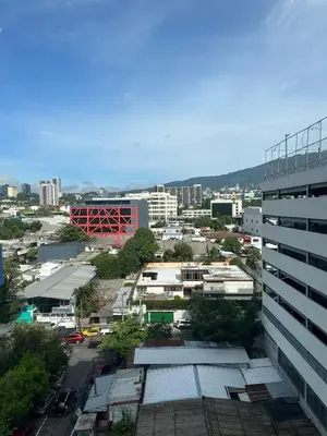a view of a city with a tall building at Beautiful apartment near Salvador del Mundo in San Salvador