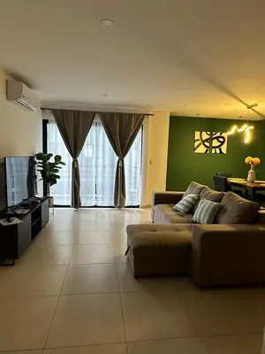 a living room with a couch and a tv at Beautiful apartment near Salvador del Mundo in San Salvador