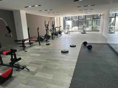 a gym with a lot of exercise equipment in a room at Beautiful apartment near Salvador del Mundo in San Salvador