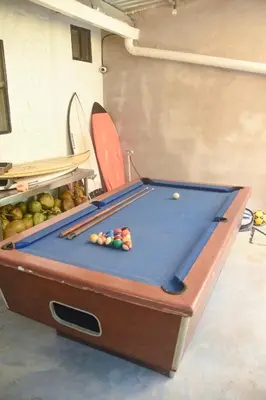 a pool table in a room with at The Duck Dive El Tunco in Tamanique