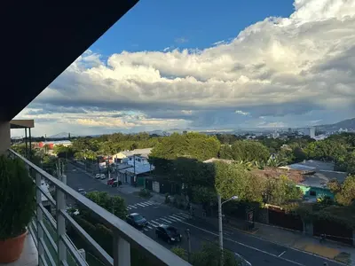 a balcony with a view of a street and a city at Moderno, acogedor y privado, en San Salvador in San Salvador