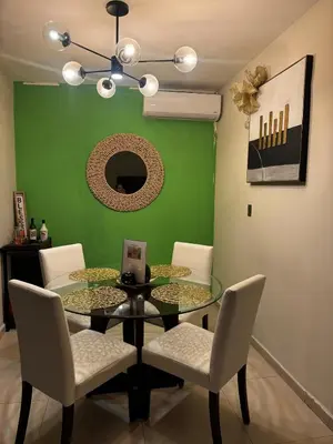 a dining room with a glass table and white chairs at Moderno, acogedor y privado, en San Salvador in San Salvador