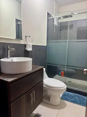 a bathroom with a sink and a toilet and a shower at Moderno, acogedor y privado, en San Salvador in San Salvador