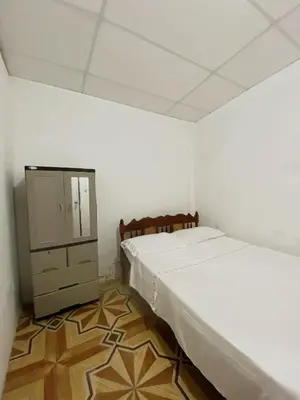 a bedroom with a bed and a cabinet in it at Aguiñada's house en el Rosario La Paz in El Rosario