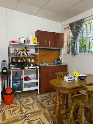 a kitchen with a table and a sink and a table at Aguiñada's house en el Rosario La Paz in El Rosario